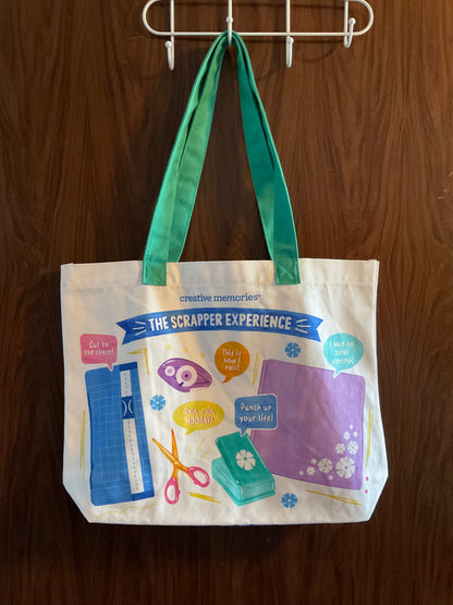 Tote bag with colorful graphics and text hanging on a hook. 
