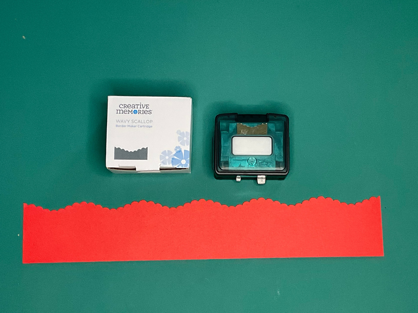 Wavy Scallop Creative Memories Border Maker Cartridge, with sample cut on red paper. 